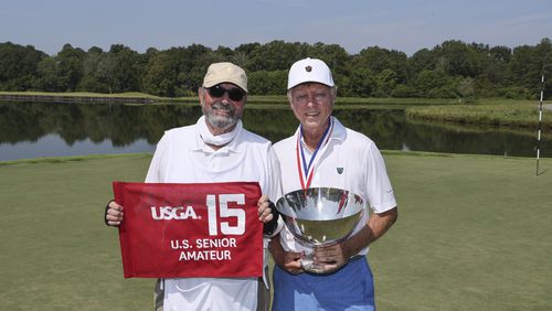 Louis Brown holds the Frederick L. Dold Championship Trophy alongside caddie Hawk Nucara after winning the final match 4 and 3 at the 2024 U.S. Senior Amateur at The Honors Course in Ooltewah, Tenn. on Thursday, Aug. 29, 2024. (Jeff Haynes/USGA)