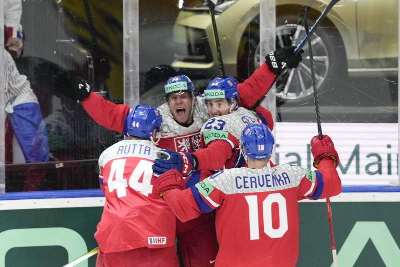 Czech Republic's Ondrej Kase celebrates with teammates after scoring his side's third goal during the semi final match between Sweden and Czech Republic at the Ice Hockey World Championships in Prague, Czech Republic, Saturday, May 25, 2024. (AP Photo/Darko Vojinovic)