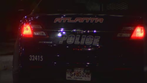 An Atlanta police patrol car at the scene of a fatal shooting on Huff Road.