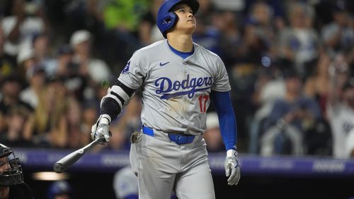 Los Angeles Dodgers' Shohei Ohtani watches the flight of his three-run home run off Colorado Rockies relief pitcher Anthony Molina in the sixth inning of a baseball game Friday, Sept. 27, 2024, in Denver. (AP Photo/David Zalubowski)