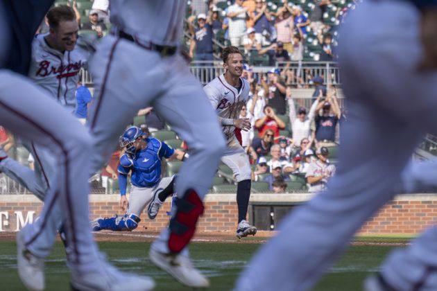 Atlanta Braves' Eli White, center, celebrates after scoring the winning run in the 11th inning of a baseball game against the Toronto Blue Jays, Sunday, Sept. 8, 2024, in Atlanta. (AP Photo/Erik Rank)