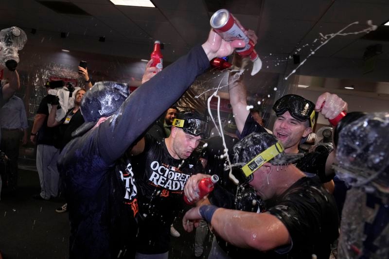 The Detroit Tigers celebrate in the clubhouse after defeating the Houston Astros in Game 2 to clinch the AL Wild Card baseball series, Wednesday, Oct. 2, 2024, in Houston. (AP Photo/Kevin M. Cox)