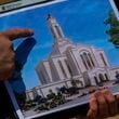 Bud Stoddard, a regional church leader, holds a rendering of the temple planned by The Church of Jesus Christ of Latter-day Saints at a site near Las Vegas, May 16, 2024. (AP Photo/Ty ONeil)