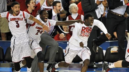 The Louisville Cardinals celebrate their win over the Michigan Wolverines.
