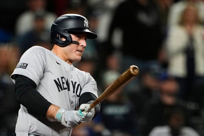 New York Yankees' Anthony Rizzo follows through on an RBI double against the Seattle Mariners during the 10th inning of a baseball game Wednesday, Sept. 18, 2024, in Seattle. (AP Photo/Lindsey Wasson)