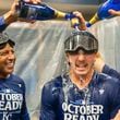 Kansas City Royals shortstop Bobby Witt Jr., center has champagne poured on him by teammates during the celebration in the locker room after a baseball game against the Atlanta Braves, Friday, Sept. 27, 2024, in Atlanta. (AP Photo/Jason Allen)