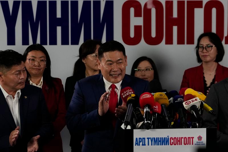 Mongolian Prime Minister Oyun-Erdene Luvsannamsrai applauds after speaking at a press conference on the results of the parliamentary elections held at the Mongolian People's Party headquarters in Ulaanbaatar, Mongolia in the early hours of Saturday, June 29, 2024. Preliminary results reported by Mongolia's ruling party show that the party has won a parliamentary election but by only a slim majority. (AP Photo/Ng Han Guan)