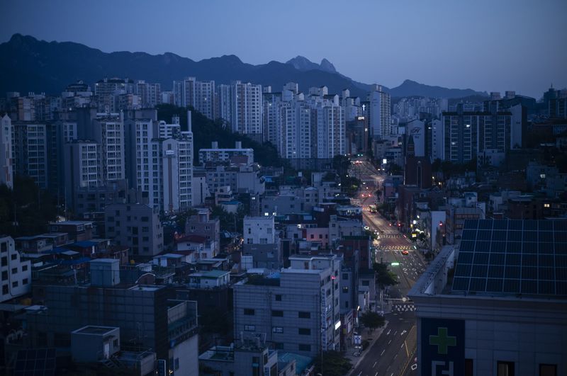 Cars drive along quiet roads at dawn in Seoul with Bukhan Mountain in the distance, Friday, May 17, 2024. (AP Photo/Jae C. Hong)