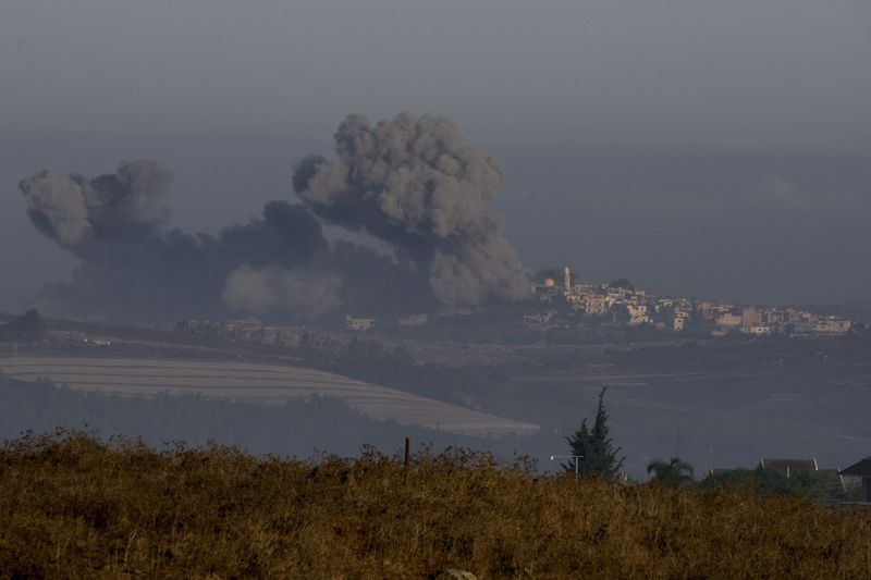 Smoke rises following Israeli bombardment in southern Lebanon as seen from northern Israel, Sunday, Oct. 6, 2024. (AP Photo/Baz Ratner)