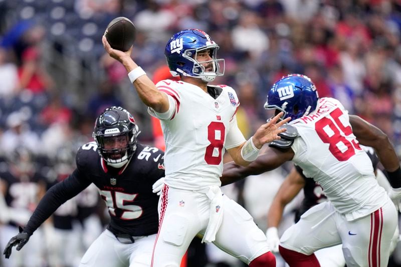 New York Giants quarterback Daniel Jones (8) throws a pass under pressure from Houston Texans defensive end Derek Barnett (95) in the first half of a preseason NFL football game, Saturday, Aug. 17, 2024, in Houston. (AP Photo/Eric Gay)