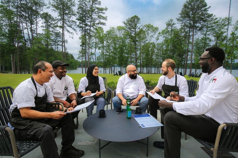 Bellout Zouhair (center) meets with members of his crew at Reynolds Lake Oconee. Courtesy of Reynolds Lake Oconee