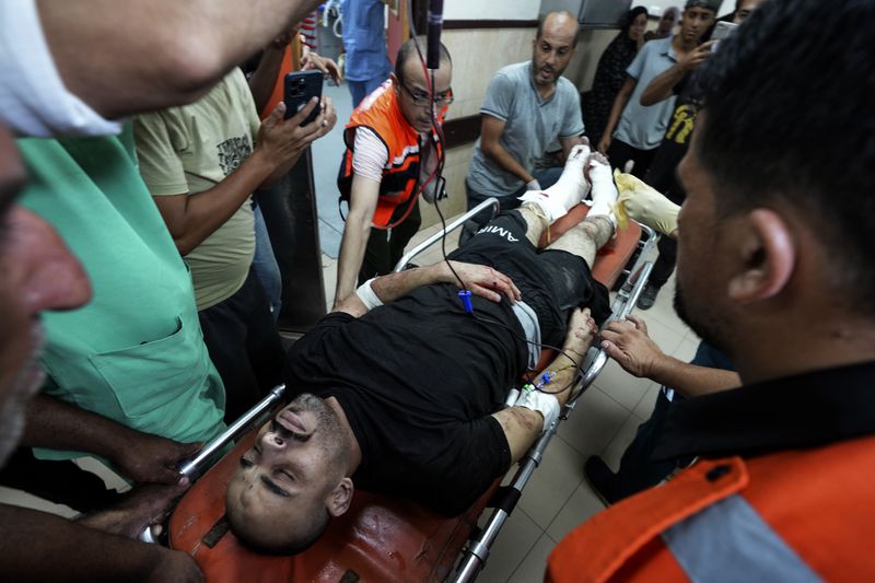 A Palestinian wounded in an Israeli bombardment of Nuseirat refugee camp is brought to al-Aqsa Martyrs Hospital in Deir al Balah, central Gaza Strip, late Thursday, June 27, 2024. (AP Photo/Abdel Kareem Hana)