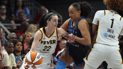 Indiana Fever guard Caitlin Clark (22) tries to get past Atlanta Dream guard Haley Jones (13) during the first half of a WNBA basketball game Friday, June 21, 2024, in Atlanta. (AP Photo/John Bazemore)