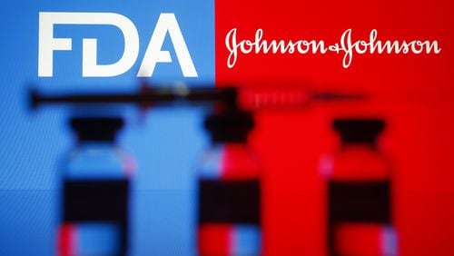 In this photo illustration Food and Drug Administration and Johnson & Johnson logos are seen in front of a medical syringe and vials. (Pavlo Gonchar/SOPA Images via ZUMA Wire/TNS)