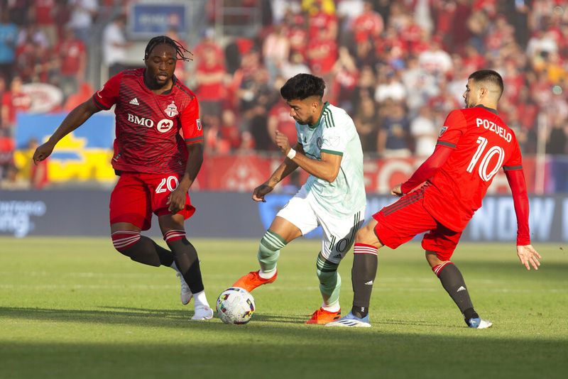 Atlanta United midfielder Marcelino Moreno, center, takes the ball between Toronto FC forward Ayo Akinola and midfielder Alejandro Pozuelo, right, during the first half of an MLS soccer match Saturday, June 25, 2022, in Toronto. (Chris Young/The Canadian Press via AP)