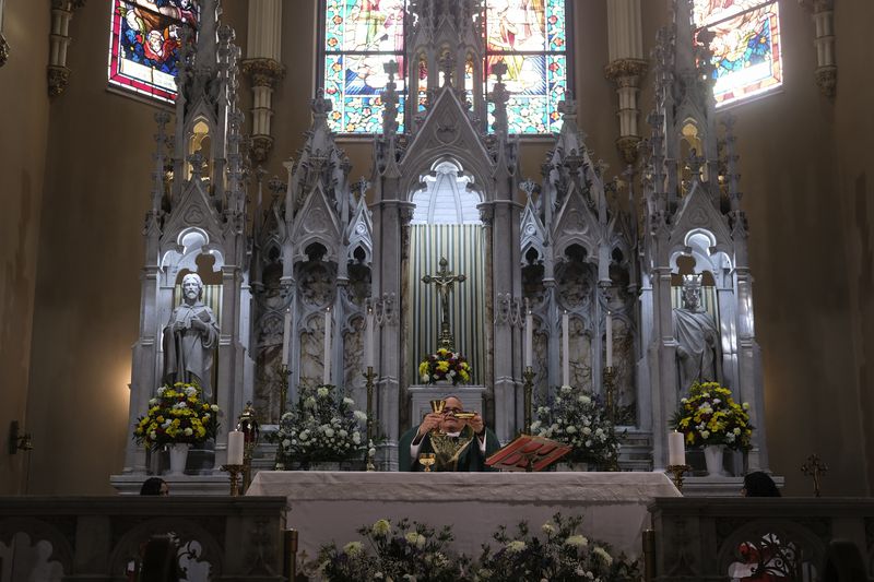 The Rev. Juan Eduardo Rodriguez, who later became pastor of St. Margaret's Church, says Mass at St. Peter the Apostle Catholic Church in Reading, Pa., on Sunday, June 9, 2024. Most of St. Peter the Apostle, and about two-thirds of Reading's 95,000 residents, are Latino. (AP Photo/Luis Andres Henao)