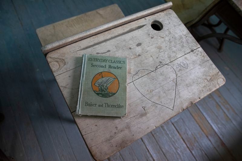 An old book rests on a desk of the Blackwell School classroom pictured during the school inauguration as the newest National Historic Site in Marfa, Texas, Saturday, Sept. 14, 2024. (AP Photo/Andres Leighton)