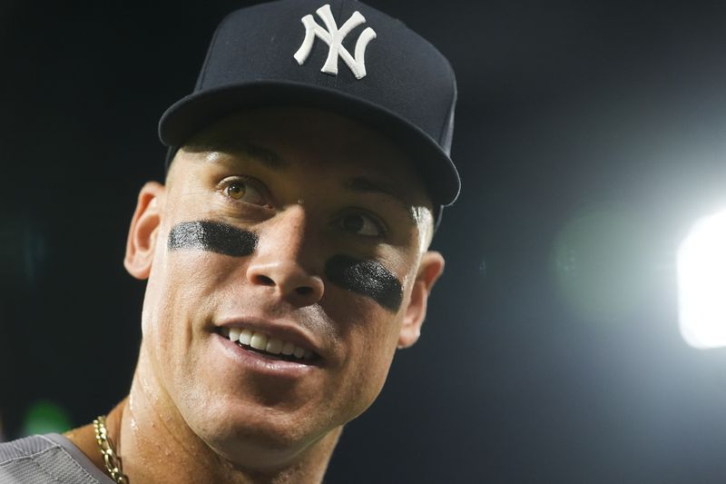 New York Yankees' Aaron Judge signals to fans after he hit his 300th career home run, the fastest player to do so in MLB history, in a baseball game against the Chicago White Sox, Wednesday, Aug. 14, 2024, in Chicago. (AP Photo/Erin Hooley)