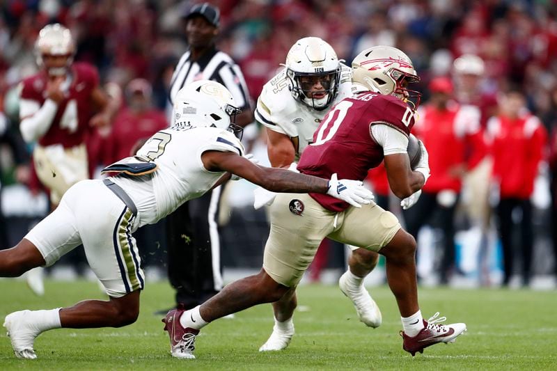 Florida's Ja'Khi Douglas, right, is challenged by Georgia's Ahmari Harvey during the NCAA college football game between Georgia Tech and Florida State at the Aviva stadium in Dublin, Saturday, Aug. 24, 2024. (AP Photo/Peter Morrison)