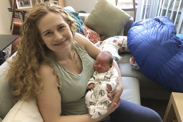 In this photo provided by Liz Chrastil, a neuroscientist with the University of California, Irvine, she her holds her newborn son in May 2020. (Courtesy Liz Chrastil via AP)