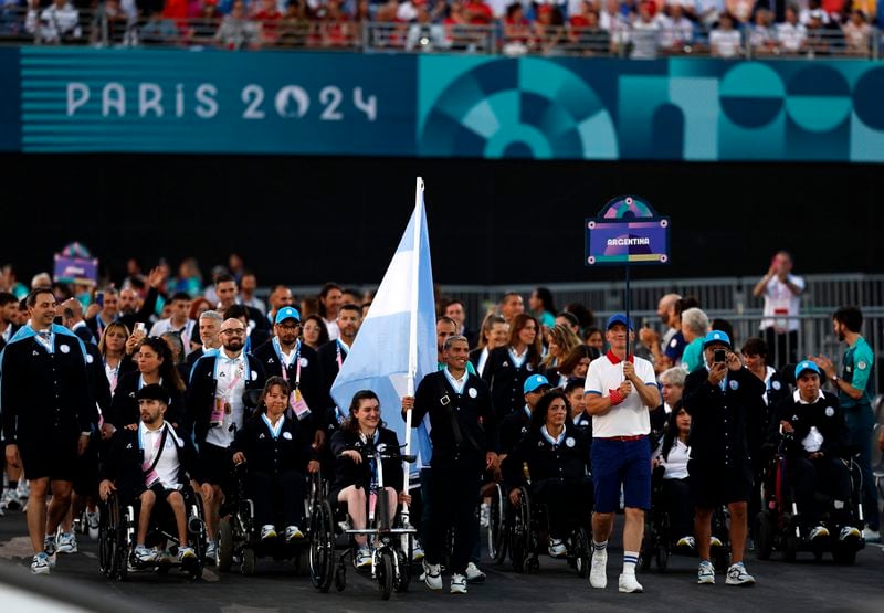 Flagbearers Hernan Barreto of Argentina and Coty Garrone of Argentina lead their contingent during the Opening Ceremony for the 2024 Paralympics, Wednesday, Aug. 28, 2024, in Paris, France. (Gonzalo Fuentes/Pool Photo via AP)