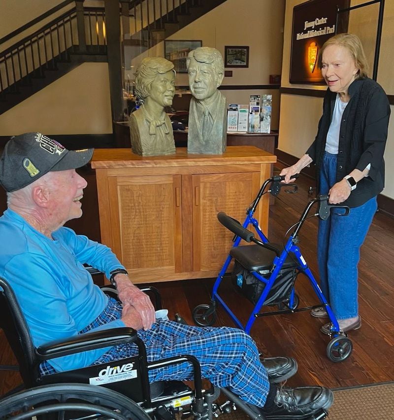 Former President Jimmy Carter and former First Lady Rosalynn Carter share big smiles in front of busts of them during a March visit to the  Jimmy Carter National Historical Park in Plains. The couple celebrated their 76th wedding anniversary on July 7, 2022.