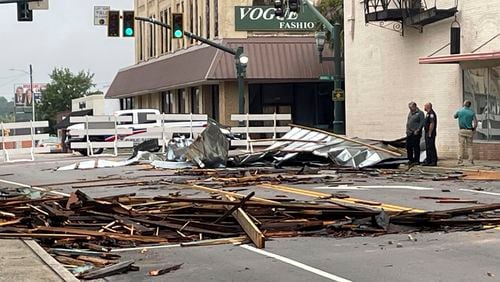 Debris, including pieces of tin from roofs and wood from awnings lay strewn in the street along Broughton Street on Wednesday, July 31, 2024 after an overnight storm passed the area. (Dionne Gleaton/The Times and Democrat via AP)