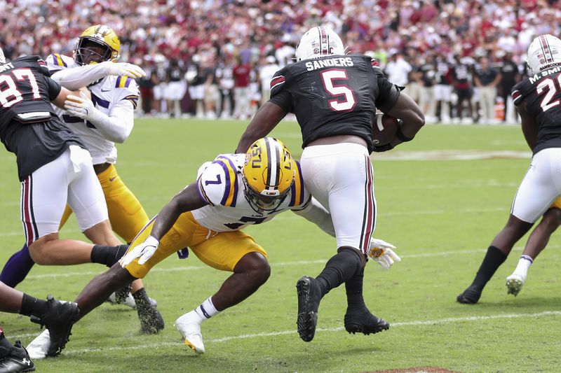 South Carolina running back Raheim Sanders (5) breaks a tackle attempt by LSU linebacker Harold Perkins Jr. (7) to prevent a safety in the end zone during the second half of an NCAA college football game, Saturday, Sept. 14, 2024 in Columbia, S.C. (AP Photo/Artie Walker Jr.)