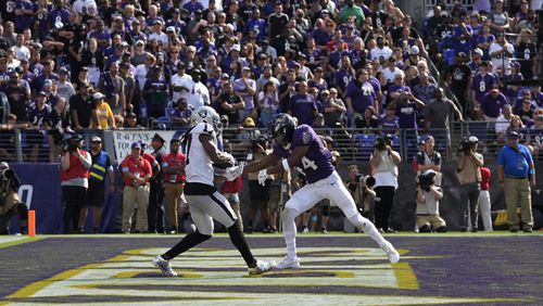 Las Vegas Raiders wide receiver Davante Adams, left, catches a touchdown pass against Baltimore Ravens cornerback Marlon Humphrey (44) during the second half of an NFL football game, Sunday, Sept. 15, 2024, in Baltimore. (AP Photo/Stephanie Scarbrough)