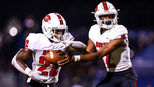 North Gwinnett quarterback Ethan Washington (2) hands the ball off to running back Brinston Williams (22) during Friday's game against Parkview in Lilburn. North Gwinnett prevailed 34-27. Casey Sykes/Special to the AJC