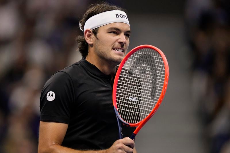 Taylor Fritz, of the United States, returns a shot to Frances Tiafoe, of the United States, during the men's singles semifinal of the U.S. Open tennis championships, Friday, Sept. 6, 2024, in New York. (AP Photo/Frank Franklin II)