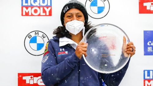 Elana Meyers Taylor from the United States poses at the award ceremony after winning the women's monobob at the Bobsled World Cup race in Igls, near Innsbruck, Austria in Igls, Austria, Saturday, Nov. 27, 2021. (AP Photo/Lisa Leutner)