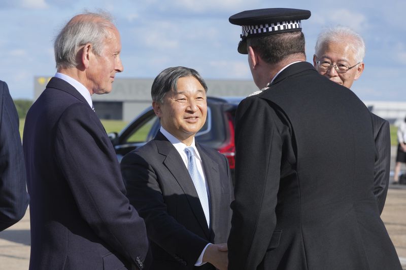 Emperor Naruhito is greeted by dignities as he and Empress Masako arrive at Stansted Airport, England, Saturday, June 22, 2024, ahead of a state visit. The state visit begins Tuesday, when King Charles III and Queen Camilla will formally welcome the Emperor and Empress before taking a ceremonial carriage ride to Buckingham Palace. (AP Photo/Kin Cheung)
