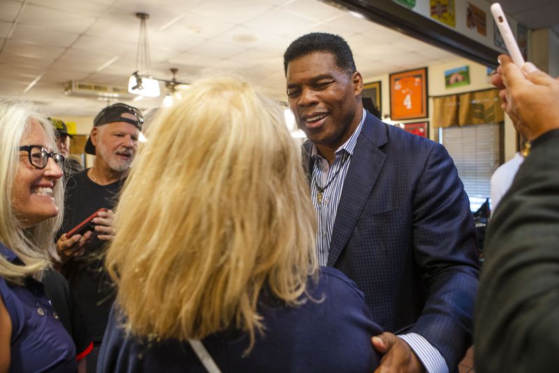 Herschel Walker meets Jan Smythe, a Roswell resident, during a meet and greet event on Wednesday, July 27, 2022, at Longstreet Cafe in Gainesville, Georgia. Fox & Friends broadcasted live from the restaurant during which co-host Brian Kilmeade interviewed Walker. CHRISTINA MATACOTTA FOR THE ATLANTA JOURNAL-CONSTITUTION.