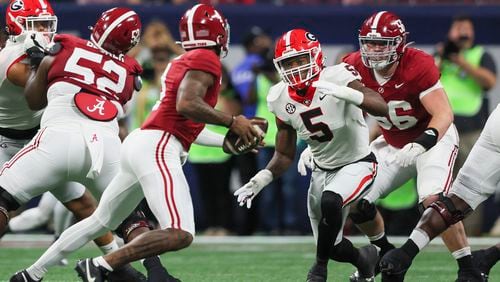 Georgia linebacker Raylen Wilson (5) pursues Alabama Crimson Tide quarterback Jalen Milroe (4) during the SEC Championship football game at the Mercedes-Benz Stadium in Atlanta, on Saturday, December 2, 2023. Alabama won 27-24. (Jason Getz / Jason.Getz@ajc.com)