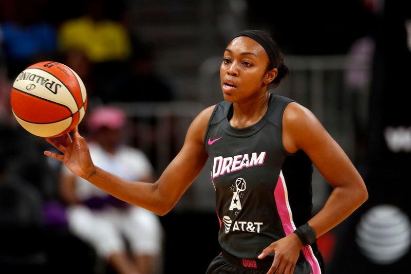 FILE - Atlanta Dream guard Renee Montgomery (21) passes the ball in the first half of a WNBA basketball game against the Chicago Sky in Atlanta, Tuesday, Aug. 20, 2019. Magic Johnson's love of basketball motivated him to save the Los Angeles Sparks from folding and also put him on the leading edge of what is now a growing WNBA trend. Former WNBA players Sue Bird and Renee Montgomery have joined the ownership groups of the Seattle Storm and Atlanta Dream, respectively. (AP Photo/John Bazemore, File)