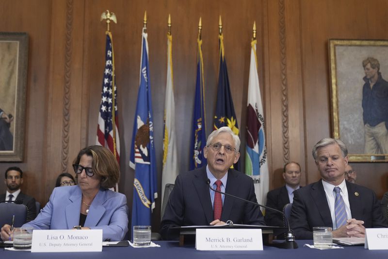 Attorney General Merrick Garland speaks during a meeting of the Justice Department's Election Threats Task Force, at the Department of Justice, Wednesday, Sept. 4, 2024, in Washington, with Deputy Attorney General Lisa Monaco, left, and FBI Director Christopher Wray, right. (AP Photo/Mark Schiefelbein)