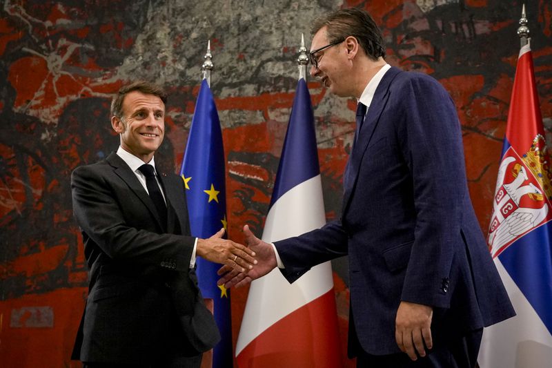 French President Emmanuel Macron, left, shakes hands with Serbian President Aleksandar Vucic in Belgrade, Serbia, Thursday, Aug. 29, 2024. French President Emmanuel Macron starts a two-day state visit to Serbia with the focus on a possible sale of 12 Rafale multi-purpose fighter jets to a country that has maintained close ties to Russia despite its aggression on Ukraine. (AP Photo/Darko Vojinovic)