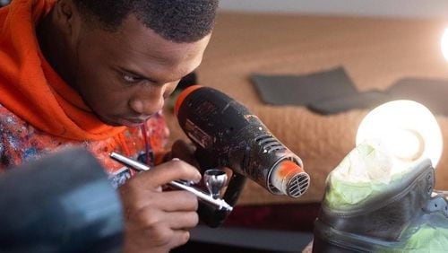 As a young kid, Elijah Rutland asked his parents to buy him a pair of sneakers. When they wouldn't, he began drawing and designing shoes that he now custom paints and sells through his company, Fix My Sole. (Photo provided by Elijah Rutland)