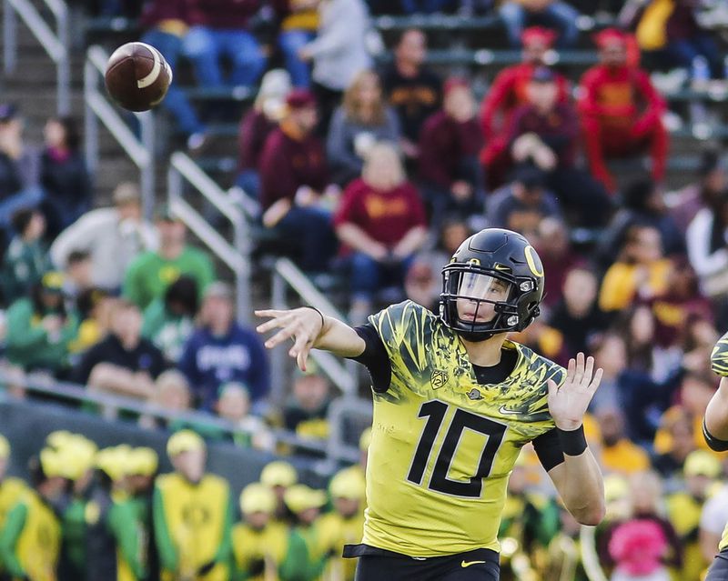 FILE- Oregon quarterback Justin Herbert passes in the second quarter against Arizona in an NCAA college football game in Eugene, Ore., Oct. 29, 2016. (AP Photo/Thomas Boyd, File)