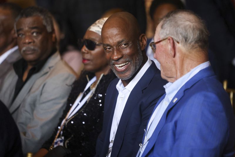 Hall of Fame first baseman Fred McGriff, a former Braves star, talks with Hall of Fame starting pitcher Jim Kaat before the start of the event to unveil the Hank Aaron statue by the grand staircase at the National Baseball Hall of Fame, Thursday, May 23, 2024, in Cooperstown, NY. (Jason Getz / AJC)
