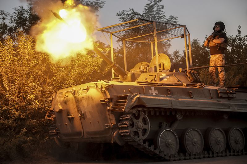 In this photo provided by Ukraine's 24th Mechanised Brigade press service, servicemen of 24th mechanised brigade fire from BRM1k infantry fighting vehicle towards Russian positions near Chasiv Yar town, in Donetsk region, Ukraine, Saturday Aug. 17, 2024. (Oleg Petrasiuk/Ukrainian 24th Mechanised Brigade via AP)