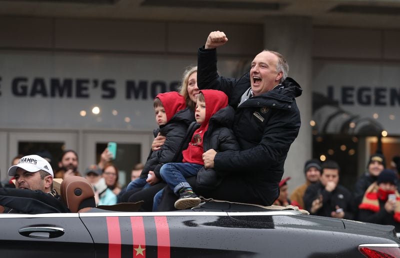 December 10, 2018 - Atlanta, Ga: Atlanta United President Darren Eales celebrates with fans as he rides with his family during the Atlanta United MLS Cup victory parade along Marietta Street Monday, December 10, 2018, in Atlanta.  (JASON GETZ/SPECIAL TO THE AJC)