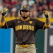 San Diego Padres' Luis Arraez celebrates after his double against the Arizona Diamondbacks during the sixth inning of a baseball game, Sunday, Sept. 29, 2024, in Phoenix. (AP Photo/Darryl Webb)