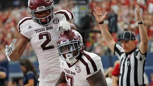 Texas A&M Aggies running back Keith Ford (7) and wide receiver Jhamon Ausbon (2) celebrate after Ford's 44-yard touchdown run in the third quarter on Saturday, Sept. 23, 2017 in the Southwest Classic in Arlington, Texas. (Paul Moseley/Fort Worth Star-Telegram/TNS)
