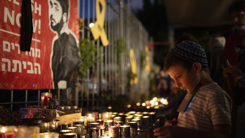 People light candles during a Sept. 1 vigil in Jerusalem in memory of slain hostage Hersh Goldberg-Polin. (Leo Correa/AP)