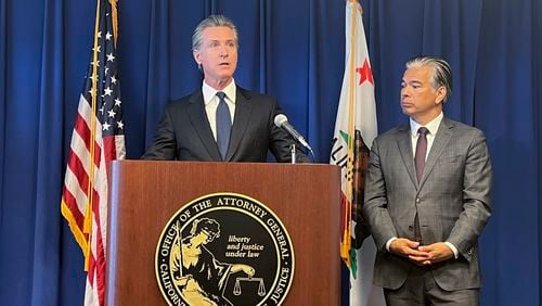 California Gov. Gavin Newsom, left, speaks next to Attorney General Rob Bonta during a press conference regarding a settlement with the city of Elk Grove, Wednesday, Sept. 4, 2024, in Sacramento, Calif. (AP Photo/Sophie Austin)