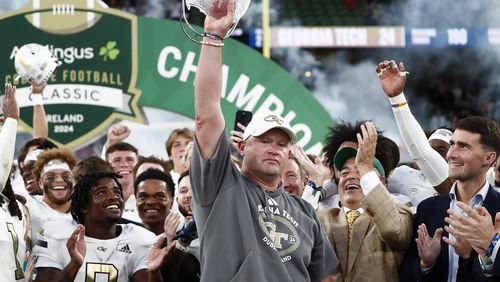 Georgia Tech coach Brent Key celebrates with his team after the game between Georgia Tech and Florida State at Aviva Stadium in Dublin, Saturday, Aug. 24, 2024. (AP Photo/Peter Morrison)