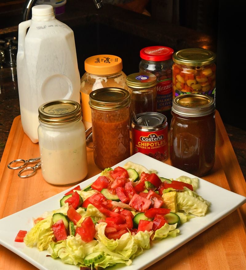 Turn leftover ingredients into homemade salad dressings. (From left to right in jars) ranch dressing, chipotle-honey vinaigrette and olive brine vinaigrette. (Styling by C. W. Cameron / Chris Hunt for The Atlanta Journal-Constitution)