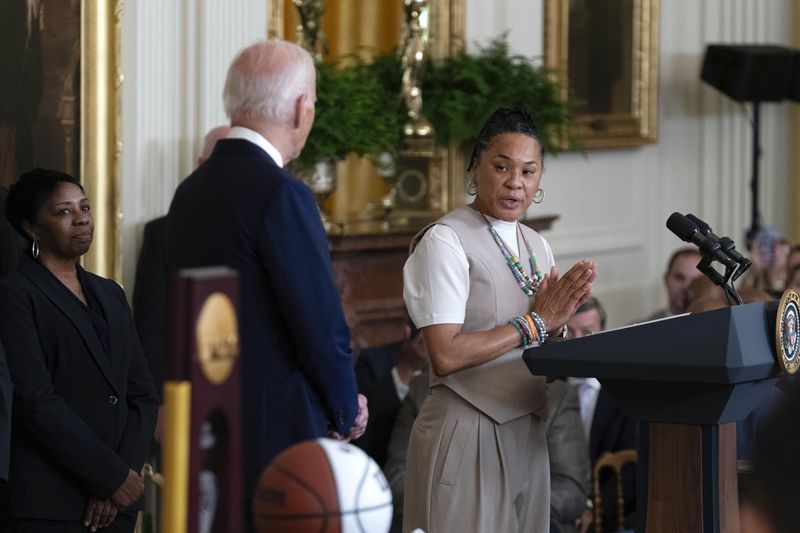 University of South Carolina Women's Basketball Team Coach Dawn Staley speaks as President Joe Biden, left, looks on, in the East Room of the White House in Washington, Tuesday, Sept. 10, 2024, during an event to welcome the University of South Carolina Gamecocks Women's Basketball Team and celebrate their 2023-2024 NCAA championship season. (AP Photo/Jose Luis Magana)